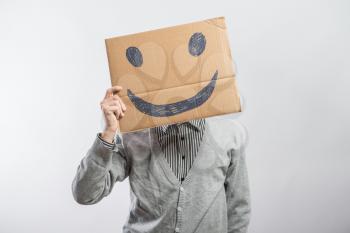 Man with the painted happy smile on the sheet of paper
