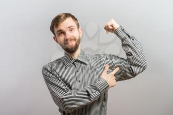 young man showing his muscles against white background