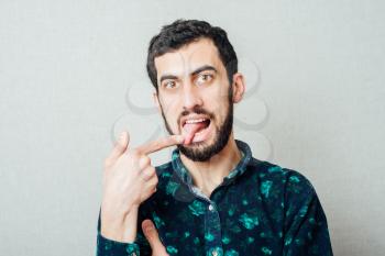 young man with finger in tongue