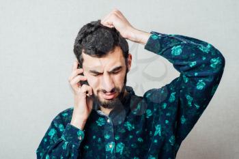 Shocked businessman Beard reads the message on the phone bad news