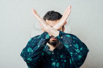 Young hipster man making time out gesture