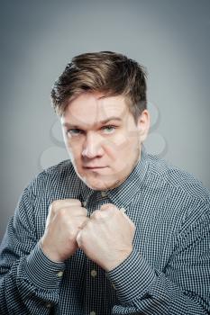 Portrait Of Angry Young Man Clenching His Fist