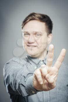 young man in showing victory or peace sign