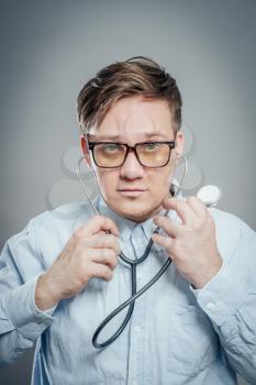 The doctor in a white lab coat holding a stethoscope