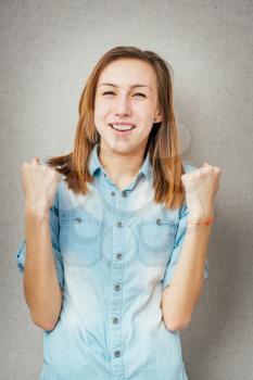 woman victory gesture hands up. isolated on gray background