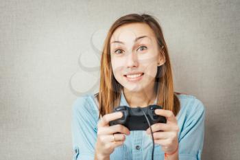 Young happy women plays a game by joystick
