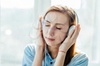 girl in headphones with eyes closed