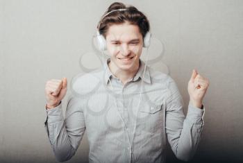 portrait of a young happy man listening to music