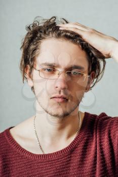 guy with glasses can't remembers holding his head