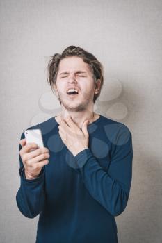 A man reading bad news on the phone, sms. Gray background