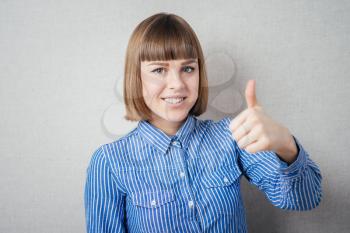 young woman showing thumb up sign