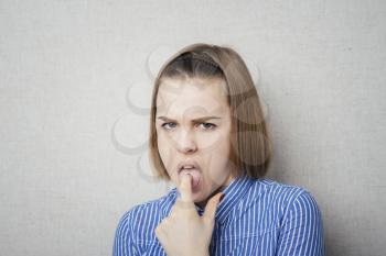 young girl disgust and finger in mouth
