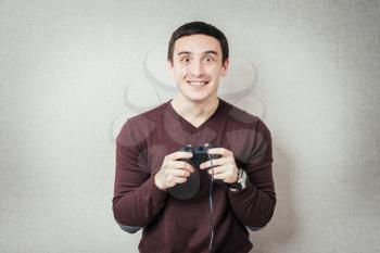 Excited young man playing video games. 