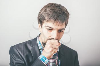 bearded businessman coughing
