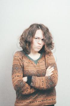 Portrait of a teenager brunette girl with pouting sad expression