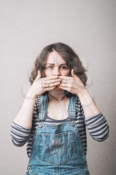 beautiful  girl covers her mouth with her hands