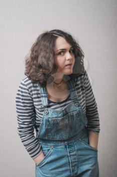 woman overhears dressed in overalls