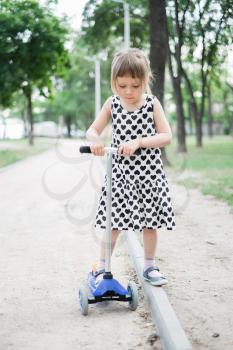 little girl with a scooter