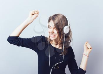 portrait of a young woman listening to music with headphones
