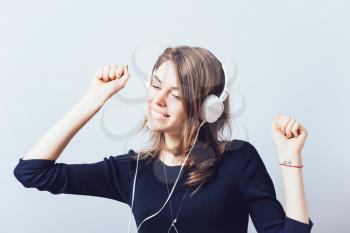 portrait of a young woman listening to music with headphones