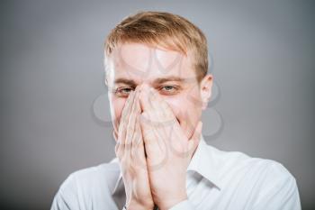 Closeup portrait of laughing excited smiling happy man covering mouth pointing at you with index finger, isolated on white background. Positive human emotion facial expression feeling, body language