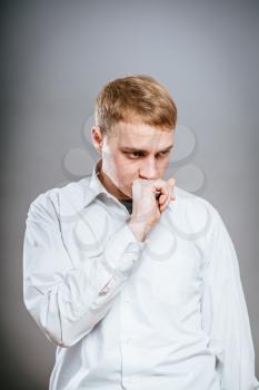 Puzzled handsome young man scratching his head with his hand as he looks at the camera with an uncertain perturbed expression, isolated on white