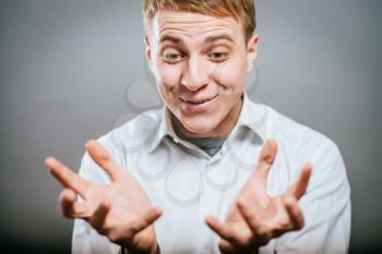Closeup portrait, happy young handsome man looking shocked surprised in full disbelief hands in air open mouth eyes. Positive human emotion facial expression feeling