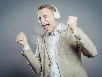 young man singing with loud music in the ears
