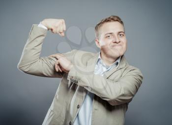 Young blond man in suit/ you see I strong. gesture. photo.