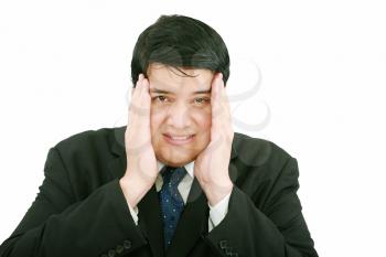 Close-up of a businessman with a migraine holding his temples.