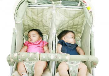 twins sleeping in their stroller