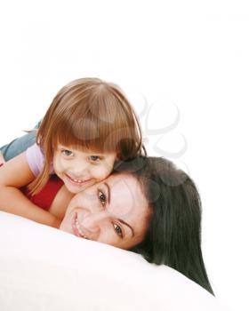 Young Mother and daugther embracing on bed 
