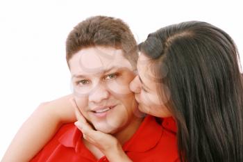 Young woman kissing her boyfriend 
