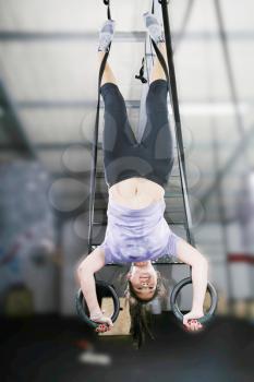 carries out difficult exercise, sports gymnastics with a dark background