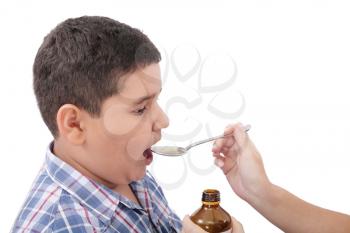 Child taking cough medicine because of the flu 