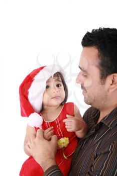 Father and daughter looking happy wearing santa Christmas hat. Focus on the baby
