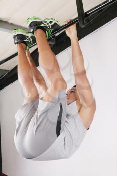 The sportsman the guy, carries out difficult exercise, sports gymnastics, on gym