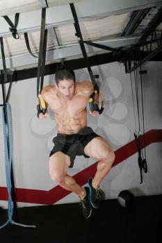 The sportsman the guy, carries out difficult exercise, sports gymnastics.  Ring dip Crossfit exercise.