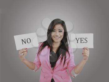 Business young woman trying to make a decision between Yes or No choice 

