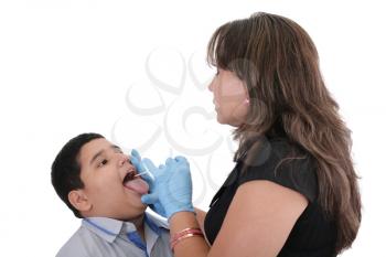 Child at the physician checking his throat