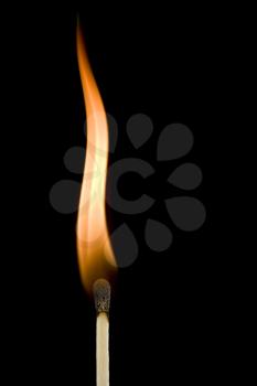 Macro of a burning matchstick flame in the dark