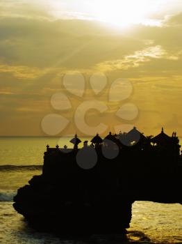 Tanah lot small temple on the rock silhouette at sunset, Bali, Indonesia