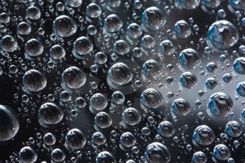 Royalty Free Photo of a Closeup of Water Drops on a Smooth Surface