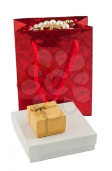 Royalty Free Photo of a Gift Bag with Jewelery and a Couple of Presents