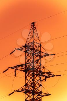 Image of power transmission tower with cables in bright tones