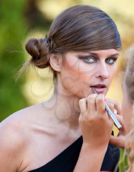 Royalty Free Photo of a Woman Getting Makeup Applied