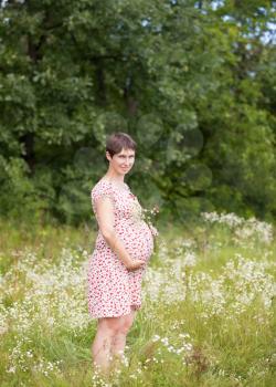 Royalty Free Photo of a Pregnant Woman in a Meadow