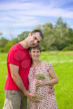 Royalty Free Photo of a Man Hugging a Pregnant Woman