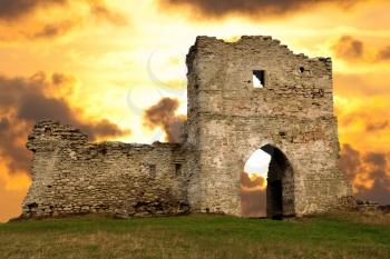 Ruined gates of cossack castle at sunset

