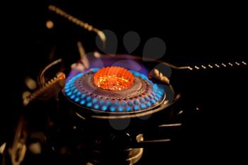 Flame in gas stove on dark background
